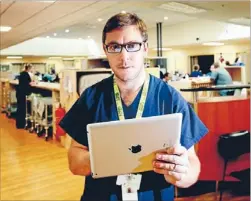  ?? Photo: KENT BLECHYNDEN ?? New programme: Clinical nurse educator Pete Carr at Wellington Hospital with an ipad used in mental health assessment­s for young drunk people.