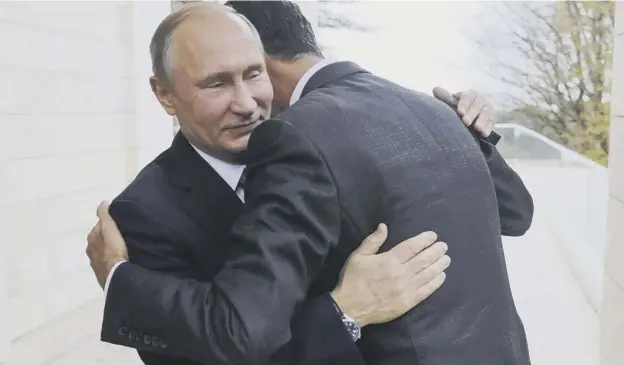  ?? PICTURE: AP ?? 0 Russian president Vladimir Putin, left, embraces Syrian president Bashar Assad as the pair met for talks at the Black Sea resort of Sochi