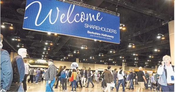  ??  ?? Profit soars:
People walk on the exhibit floor during Berkshire Hathaway annual meeting in Omaha, Nebraska, in May. The company’s quarterly operating profit rose 67%, as insurance underwriti­ng rebounded and several business units benefitted from a...