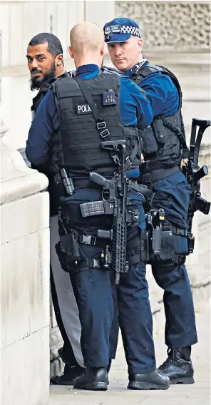  ??  ?? Terrorist Khalid Ali is detained by armed police in Whitehall near the Houses of Parliament on April 27 last year
