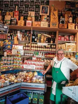  ??  ?? Franco Crivello stands by to help customers at Molinari Delicatess­en on Columbus Avenue’s North Beach neighborho­od.