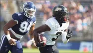  ?? Stew Milne / Associated Press ?? Purdue wide receiver David Bell (3) is pursued by UConn defensive lineman Nick Harris on Saturday.