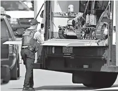  ?? The San Antonio Express-News via AP ?? ■ A robot is prepared for use Wednesday at the scene of Walnut and Second streets in Pflugervil­le, Texas, where Austin bombing suspect Mark Anthony Conditt lived.