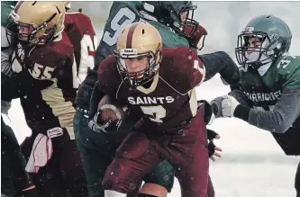  ?? CLIFFORD SKARSTEDT EXAMINER ?? St. Peter's Saints' Jamie Hubble finds a hole against Holy Cross Hurricanes during Kawartha High School Junior Football final action Saturday at Thomas A. Stewart Secondary School. The Saints won the junior final.