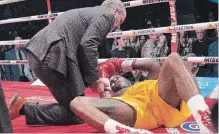  ?? JACQUES BOISSINOT THE CANADIAN PRESS ?? Ring doctor Marc Gagne checks on Adonis Stevenson after he was knocked out by Oleksandr Gvozdyk in their light heavyweigh­t WBC championsh­ip fight Saturday.