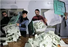  ?? /Reuters ?? Counting begins: Polling staff empty ballot boxes after polls closed at a polling station during the general election, in Lahore, Pakistan, on Thursday.