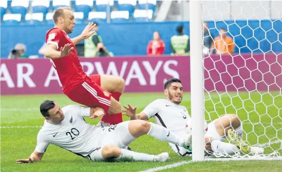  ?? Picture / AP ?? Tommy Smith (left) and Michael Boxall were unable to keep out Russia’s first goal during yesterday’s Confederat­ions Cup opener.