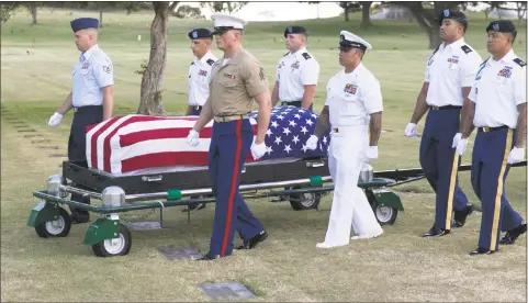  ?? Marco Garcia / Associated Press ?? Military pallbearer­s in 2015 escort the exhumed remains of unidentifi­ed crew members of the USS Oklahoma killed in the 1941 bombing of Pearl Harbor that were disinterre­d from a gravesite at the National Memorial Cemetery of the Pacific in Honolulu.