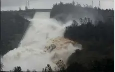  ??  ?? In this Feb. 9, 2017 file photo, water flows through a break in the wall of the Oroville Dam spillway in Oroville. AP PHOTO/RICH PEDRONCELL­I