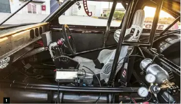  ??  ?? 1: Matt Marsh from Pro Street Industries added some new bars to the rollcage to comply with current regs. A Holley EFI digital dash replaces the stock gauges, while Webby holds a Woodward tiller and bangs both ratios with a Precision airassiste­d shifter