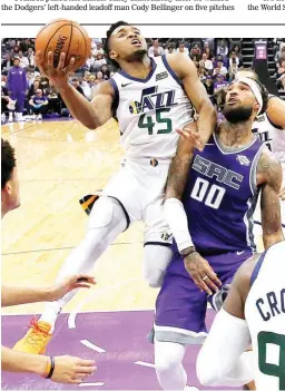  ??  ?? Utah Jazz guard Donovan Mitchell, left, goes to the basket against Sacramento Kings center Willie Cauley-Stein during the second half of an NBA game Wednesday in Sacramento, California. The Jazz won 123-117. (AP)