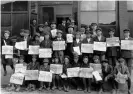  ?? Photograph: Denver Public Library Special Collection­s ?? UMWA coalminers and their sons pose holding newspapers reading ‘Trinidad Free Press’ with headlines about the strike against CF&I in Ludlow.