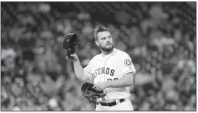  ?? AP/DAVID J. PHILLIP ?? Houston Astros starting pitcher Wade Miley looks at the scoreboard as he walks toward the dugout Tuesday after being pulled during the first inning against the Oakland Athletics in Houston.