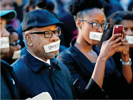  ?? [PHOTO BY STEVE SISNEY, THE OKLAHOMAN ARCHIVES] ?? George Henderson joins students at the University of Oklahoma to protest a fraternity’s racist comments on March 9, 2015.