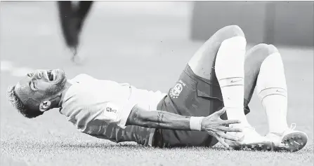  ?? MATTHIAS SCHRADER THE ASSOCIATED PRESS ?? Brazil’s Neymar grimaces in pain after a tackle by Serbia’s Adem Ljajic. It was a world-class performanc­e from a world-class flopper.