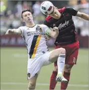  ?? Pete Christophe­r Associated Press ?? ROBBIE KEANE, left, who scored the first goal of the game, is thwarted by Portland’s Ben Zemanski.