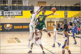  ?? PHOTOS BY ROB WORMAN ?? Chesapeake’s David Oliveras (Great Mills) goes up for the contested layup over Potomac’s Sean Patterson (St. Charles) in Friday night’s SMAC senior all-star boys basketball game at North Point High School in Waldorf. Oliveras led Chesapeake with 15...