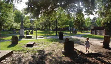  ?? GREG MERCER PHOTOS ?? The author’s daughter explores Colonial Park Cemetery, one of Savannah’s oldest burial grounds.