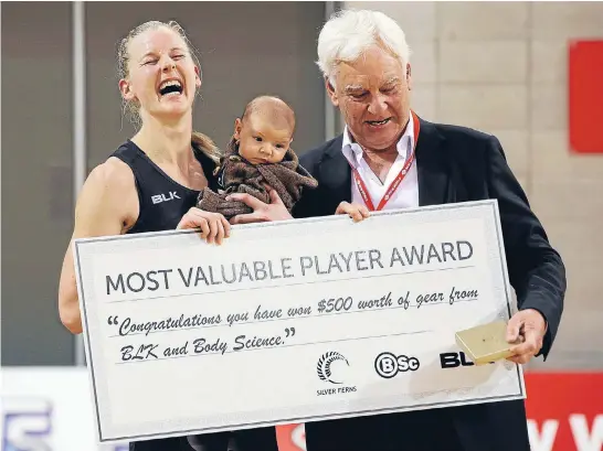  ?? Photo: GETTY IMAGES ?? Katrina Grant and baby Marcel Wiffen collect her player of the match prizes from Sir Paul Collins after the first test against Fiji on Thursday.