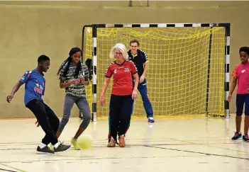  ?? RP-FOTO: JANICKI ?? Bettina Laue-Rieth (Mitte) spielt mit „ihren“Flüchtling­skindern Fußball. Und alle sind voller Begeisteru­ng dabei. Unterstütz­t wird sie von der Handball-Abteilung des TB Wülfrath.