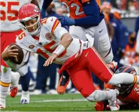  ?? JUSTIN TAFOYA/GETTY IMAGES ?? Patrick Mahomes, playing with a stomach bug, failed to throw a TD pass and lost to the Broncos for the first time in 13 tries.