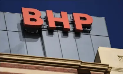  ?? Photograph: James Ross/AAP ?? BHP will bring together its Australian and UK arms into one company, leaving the London Stock Exchange, and tip its oil and gas assets into Woodside.