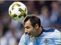  ?? Canadian Press file photo ?? Sweat splashes off the Vancouver Whitecaps’ Andrew Jacobson as he heads the ball away while defending against the Colorado Rapids during the first half of an MLS game last September in Vancouver. Jacobson announced his retirement Wednesday.