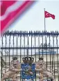  ??  ?? A Turkish flag over the Dutch consulate in Istanbul. Right, protesters in Rotterdam, and below, Fatma Betul Sayan Kaya