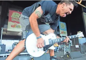  ?? ALYSSA POINTER / MILWAUKEE JOURNAL SENTINEL ?? Less Than Jake performs at the Marcus Amphitheat­er during the Vans Warped Tour 2014. The band is among those playing what could be the Vans Warped Tour’s last visit to Milwaukee on July 14.