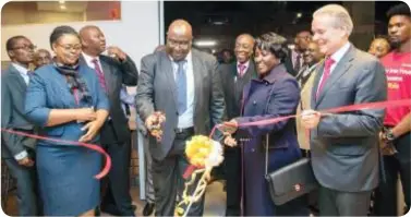  ??  ?? Finance PS Emmanuel Pamu officially opens the Refurbishe­d ZANACO Manda Hill branch as CEO Henk Mulder and Board chairperso­n Charity Lumpa look on.