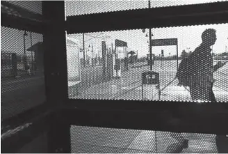  ?? Photos by RJ Sangosti, The Denver Post ?? A man walks past a bus shelter during the morning commute at the Federal Center light-rail station on Tuesday in Lakewood. A plan for a homeless housing complex in Lakewood on 59 acres of federal land near the Federal Center has drawn nearly 2,000...