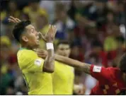  ?? ANDRE PENNER — THE ASSOCIATED PRESS ?? Belgium’s Axel Witsel holds off a challenge from Brazil’s Roberto Firmino during the quarterfin­al match between Brazil and Belgium at the 2018 soccer World Cup in the Kazan Arena, in Kazan, Russia, Friday.