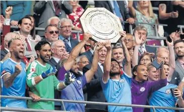  ?? AFP ?? Manchester City players celebrate with the Community Shield trophy at Wembley.