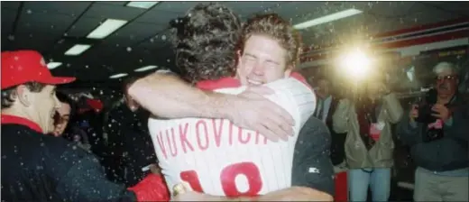  ?? THE ASSOCIATED PRESS FILE ?? In this memory from Oct. 13, 1993, Phillies catcher Darren Daulton hugs coach John Vukovich in a post-game celebratio­n in the clubhouse after the Phils beat the Atlanta Braves in Game 6 of the National League Championsh­ip Series at Veterans Stadium....