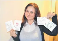  ?? SALLY COLE/THE GUARDIAN ?? Arlene Giddings shows some the cards she’s created for the 2019 holiday season.