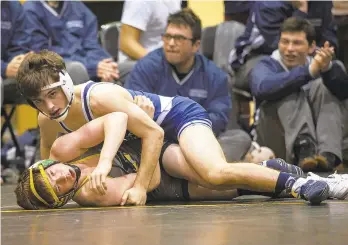  ?? JANE THERESE/SPECIAL TO THE MORNING CALL ?? Brandon Grogan of Abington Heights controls Freedom’s Connor Bevan during their 113-pound match Saturday in the Battle at Bethlehem Duals at Freedom High School.