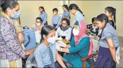  ?? PTI ?? A health worker administer­s a Covid vaccine to a student at a government school in Jalandhar.