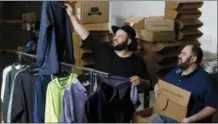  ?? THE ASSOCIATED PRESS ?? In this Aug. 11photo, co-owners Daniel Franzese, left, and Wil Cuadros select clothes for “The Winston Box” at their showroom in Gardena, Calif. The Winston Box is a monthly subscripti­on box that designs and makes its own clothes for big guys.