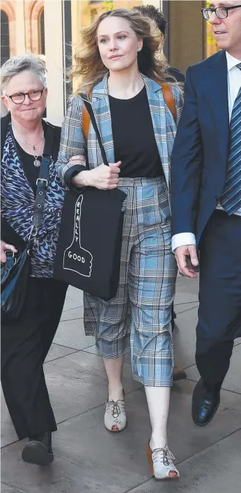  ?? Picture: AAP IMAGE ?? Actor Eryn Jean Norvill (centre) leaves the Federal Court in Sydney yesterday after giving evidence in the Geoffrey Rush defamation case.