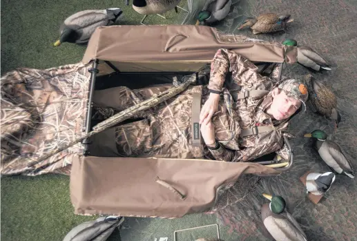  ?? Picture / Jason Oxenham ?? Duck shooter Anton Sapich trials a layout blind, one of a range of innovation­s now available.