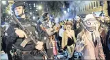  ?? PICTURE: AP ?? Police guard revellers in Greenwich Village, New York’s Halloween Parade on Tuesday after eight people were mowed down by a truck earlier in the day in the borough.