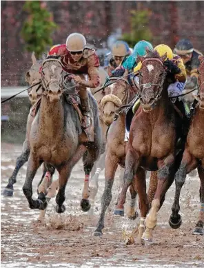  ??  ?? Always Dreaming, right, ridden by jockey John Velazquez, leads the field into the stretch du