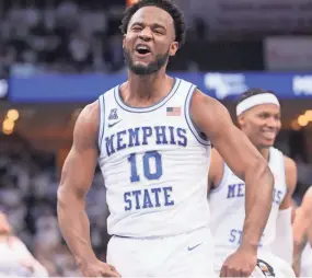  ?? JOE RONDONE/THE COMMERCIAL APPEAL ?? Memphis Tigers guard Alex Lomax celebrates as they take a 20 point first half lead against the Houston Cougars at Fedexforum on Sunday.