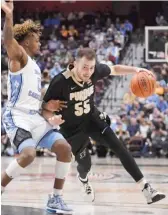  ?? JESSICA HILL/AP ?? Sasha Stefanovic drives to the hoop against North Carolina’s Anthony Harris during Purdue’s 93-84 victory in the Hall of Fame Tip-Off.