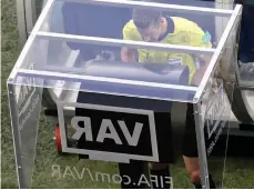  ?? AP ?? A referee watches the Video Assistant Referee (VAR) system. —