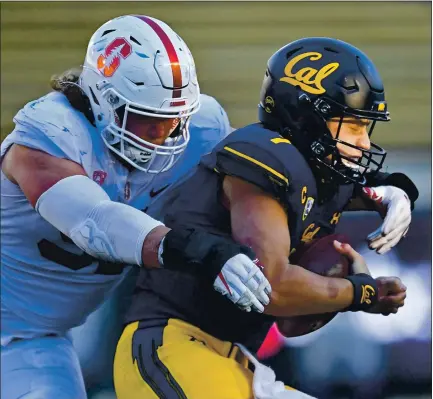  ?? PHOTOS BY JOSE CARLOS FAJARDO — STAFF PHOTOGRAPH­ER ?? Cal quarterbac­k Chase Garbers, right, is sacked by Stanford’s Thomas Schaffer during the third quarter of the 123rd Big Game on Friday.