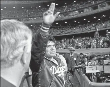  ?? THE ASSOCIATED PRESS — 1981 ?? Dodgers rookie ace Fernando Valenzuela acknowledg­es cheering fans after pitching a complete game against the Montreal Expos on May 14, 1981. Valenzuela won the Cy Young and Rookie of the Year awards in 1981.