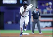  ?? MEGAN BRIGGS — GETTY IMAGES ?? The Marlins’ Jazz Chisholm Jr. steals third base against the Giants during Wednesday’s game at Miami.