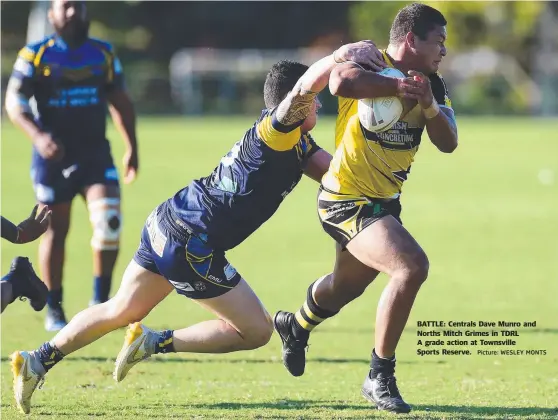  ?? Picture: WESLEY MONTS ?? BATTLE: Centrals Dave Munro and Norths Mitch Grimes in TDRL A grade action at Townsville Sports Reserve.