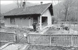  ?? DARKO VOJINOVIC/AP ?? Uros Trainovic stands in front of his house in the village of Blagojev Kamen, Serbia, a once busy mining town with 200 families is now home to eight residents.